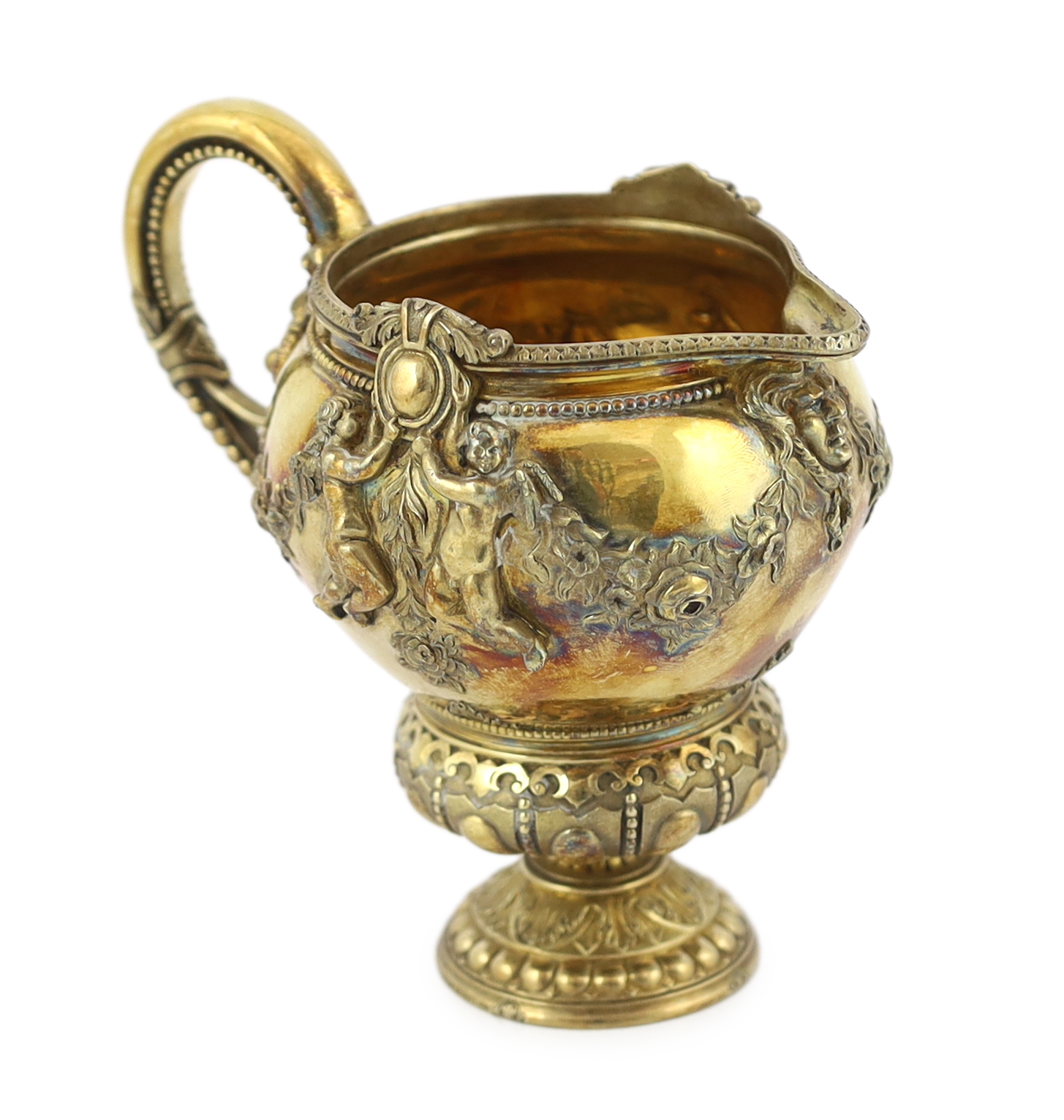 An early Victorian ornate silver gilt cream jug, by George Ivory